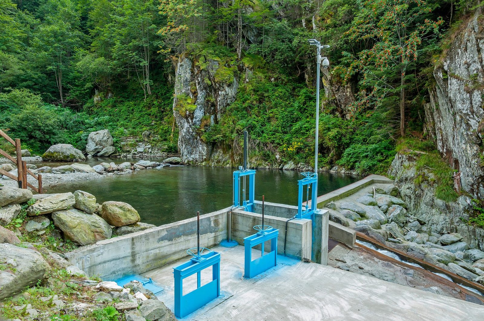 A micro hydro intake structure on a river in a forested valley